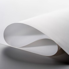 White TPU film lying in waves on a dark desk