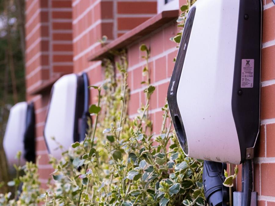 Charging stations mounted to a brick wall of a residential complex.