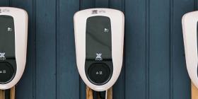 Three EV-Charging stations in a row mounted to a wooden outside wall