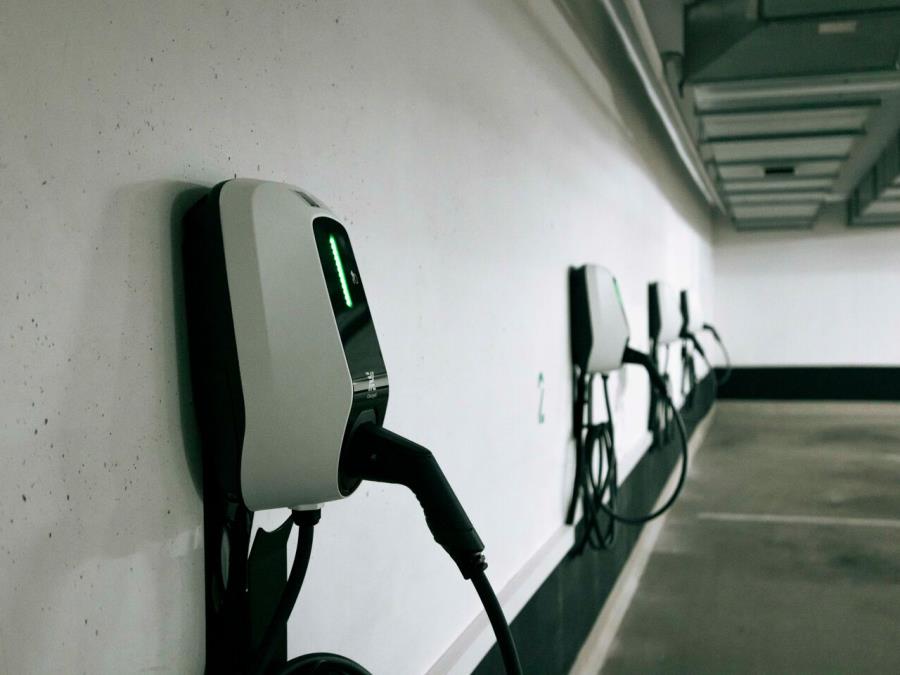 Several charging stations on an underground garage wall.