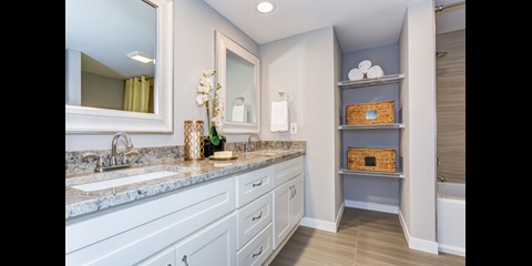 A bathroom with wooden furniture.