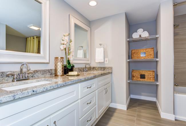 A bathroom with wooden furniture.