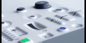 Molded plastic control panel with a variety of in-mold electronic controls including buttons and sliders.