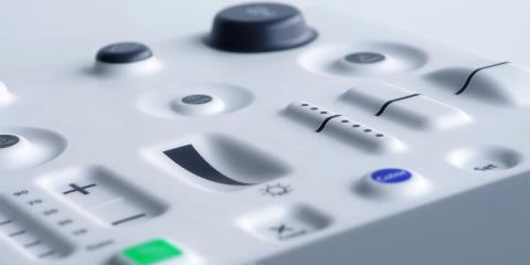 Molded plastic control panel with a variety of in-mold electronic controls including buttons and sliders.