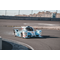 Hydrogen powered racing car taking a curve on a racetrack