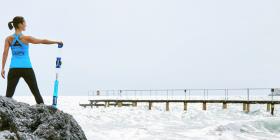 A woman with a SlashPipe  standing at the shore.