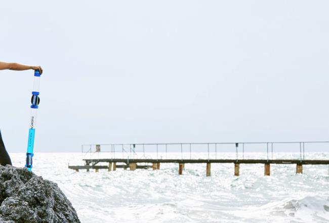 A woman with a SlashPipe standing at the shore.
