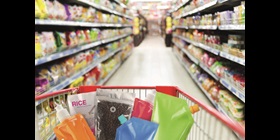 Aisle with shopping cart holding a range of unlabelled consumer goods with flexible TPU packaging