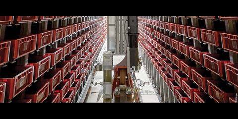 Stacker crane in high-bay warehouse aisle