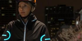 A cyclist wearing an EL cycling jacket in the nighttime