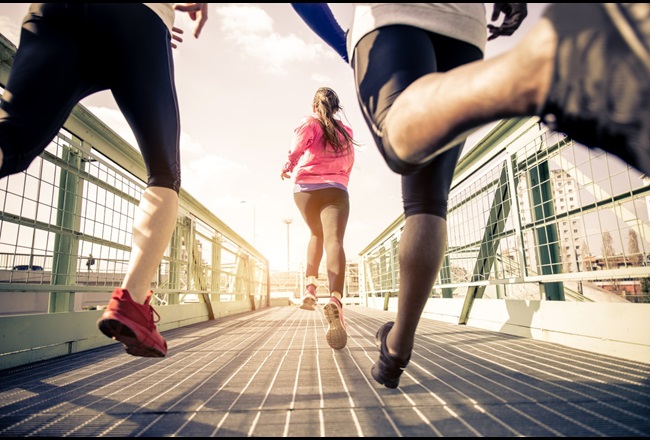 Three runners training in an urban area.