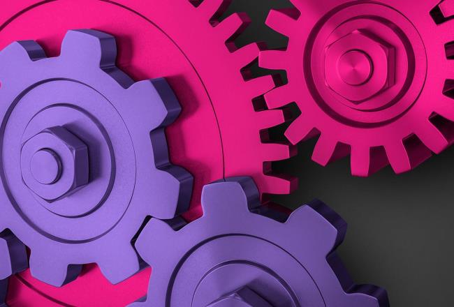 Magenta and purple industrial cogs fitting together