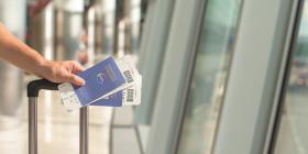 person holding a passport at the airport