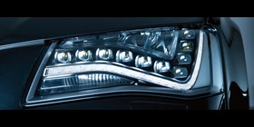 Lens produced using multi-layer injection molding (left final lens, right preform)