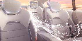 A futuristic car where a splash of water is rushing through.