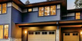 Modern residential home with blue siding and navy window frames
