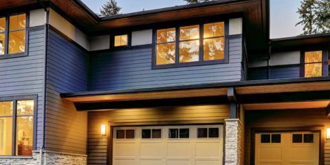 Modern residential home with blue siding and navy window frames