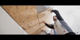 Craftsmen installing roof top insulation made of polyurethane hard foam.