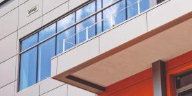 Modern building being constructed with large windows and sleek exterior