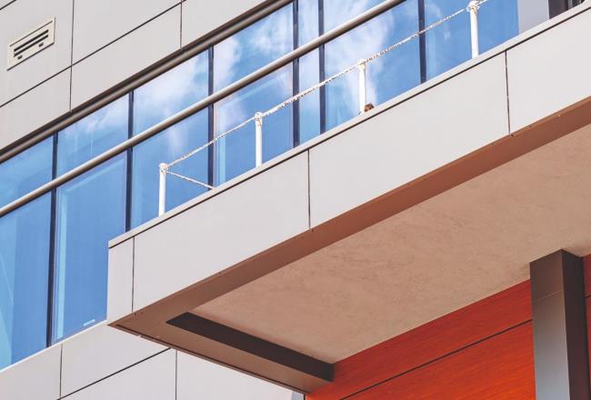 Modern building being constructed with large windows and sleek exterior
