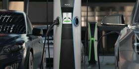 Two electric cars plugged into an electric vehicle charging station