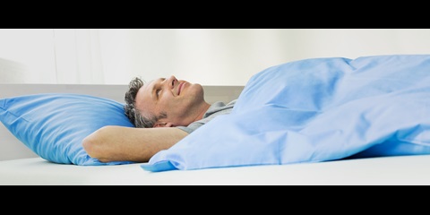 A man lying in bed.