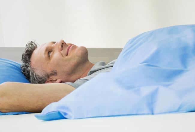 A man lying in bed.