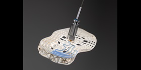 Printing head applicating adhesive on a shoe sole.