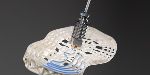 Printing head applicating adhesive on a shoe sole.