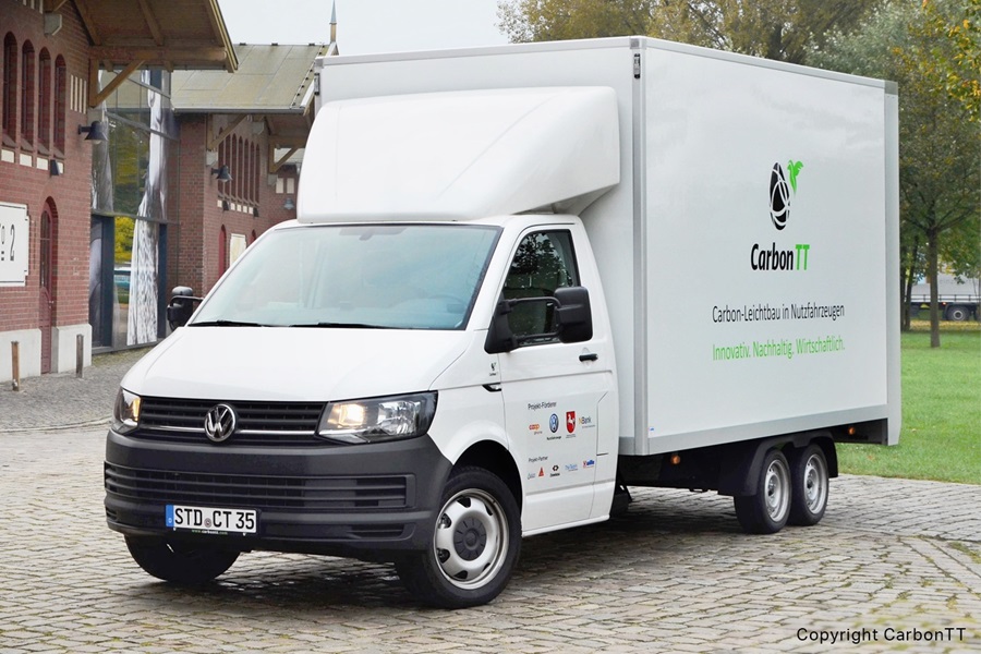 A truck in front of a brick wall building.
