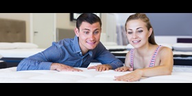Image of people inspecting the properties of a mattress