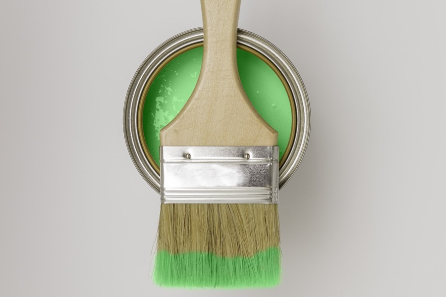 paintbrush with green paint can