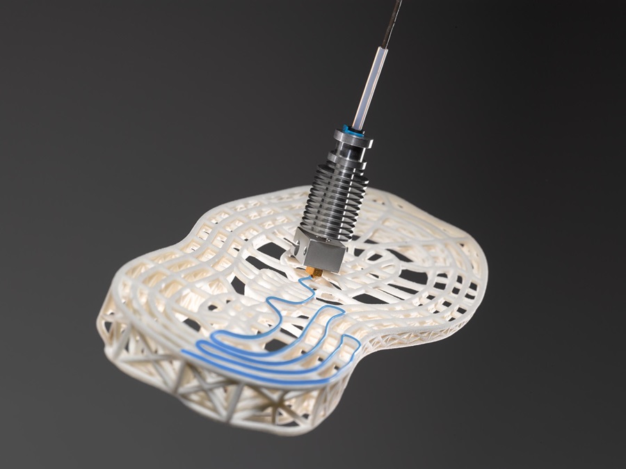 Printing head applicating adhesive on a shoe sole