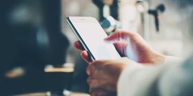 Man holds smartphone in hands for text message.