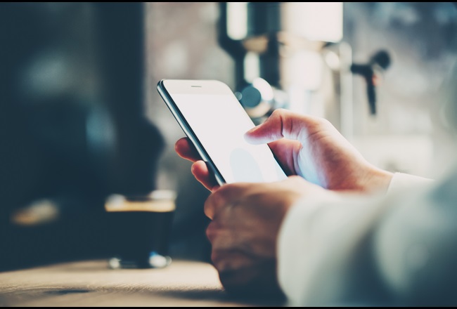 Man holds smartphone in hands for text message.