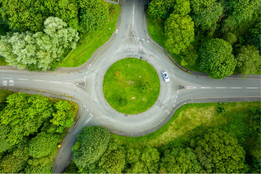 Roundabout road surrounded by trees and greenery