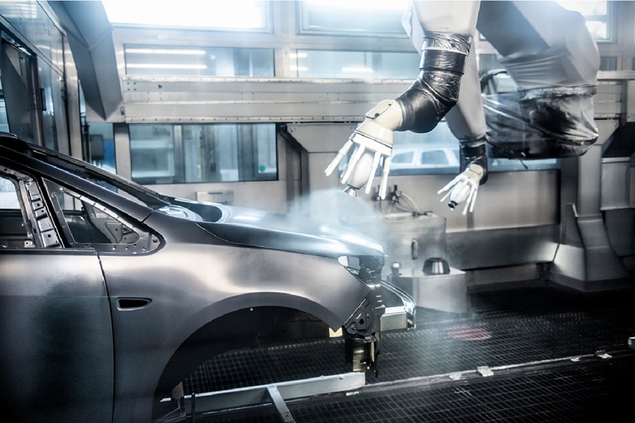 Automotive exterior shell being spray coated on automotive line