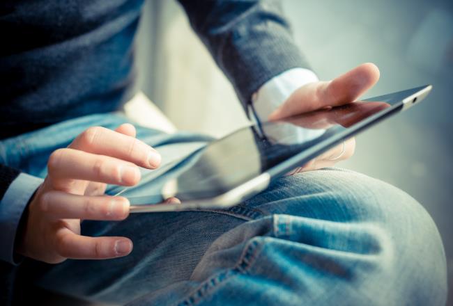 Young man is using a tablet