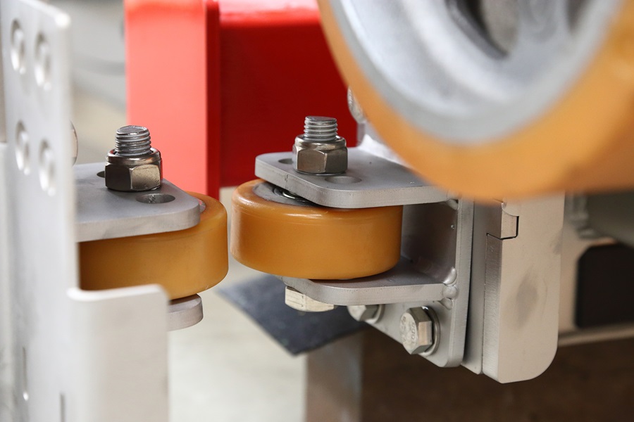Close-up view of horizontal load wheels integrated into the load tipper.