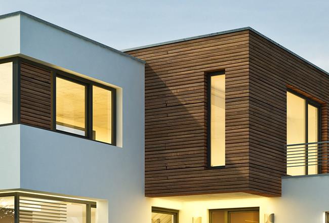 Modern architectural design showcasing a house with a striking blend of white and brown wood accents.