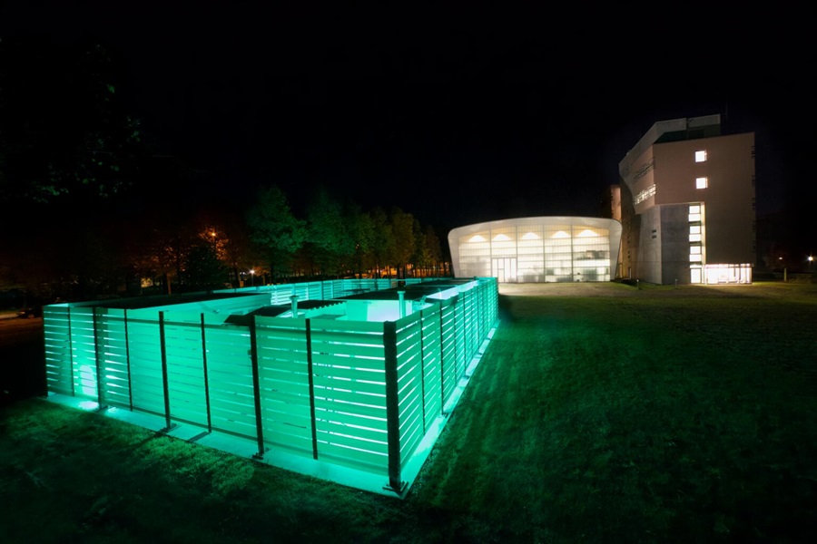 Nighttime view of composite fencing on the Fraunhofer IGCV campus showing glowing translucent effect