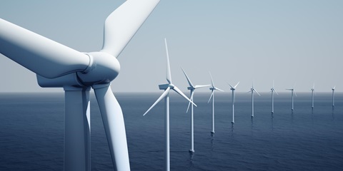 Row of offshore wind turbines on a calm ocean