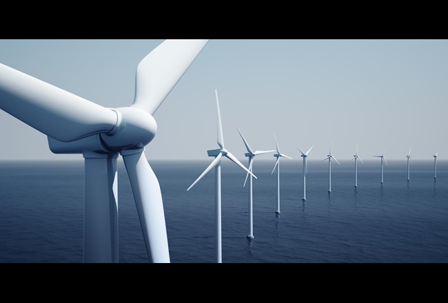 Row of offshore wind turbines on a calm ocean