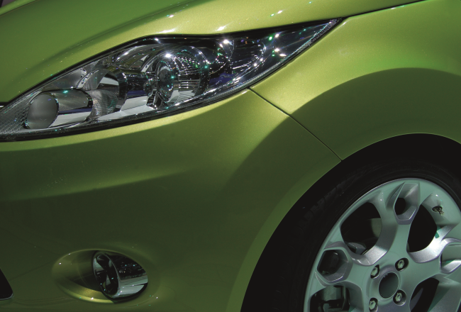 Close up of a green car front.