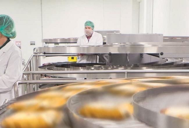 Workers on a packaging machine